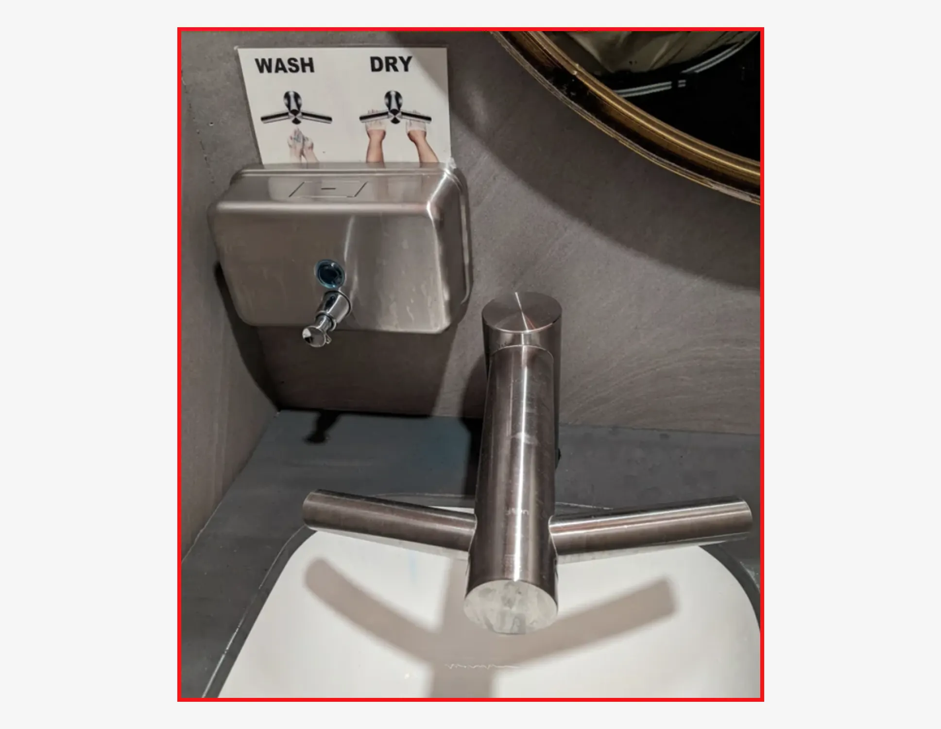 A wash-and-dry tap over a sink, with a printed sign explaining which side washes and which dries
